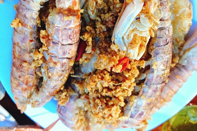 Hoi An Nightlife And Food Tour By Electric Scooter - The seafood run and the NGO-supported restaurant moment